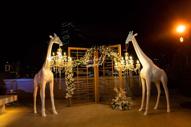 White giraffe chandelier with lights in night